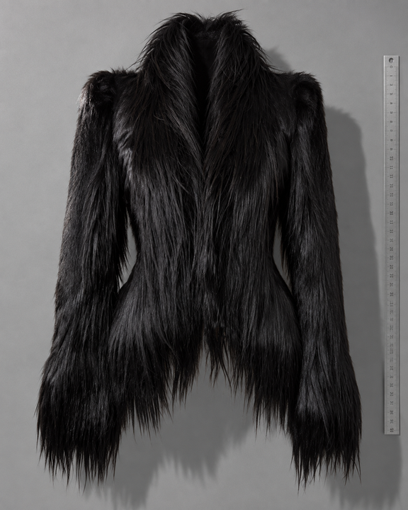 RTV-0001: front view of a black long-haired coat, displayed beside a vertical ruler on a grey background.